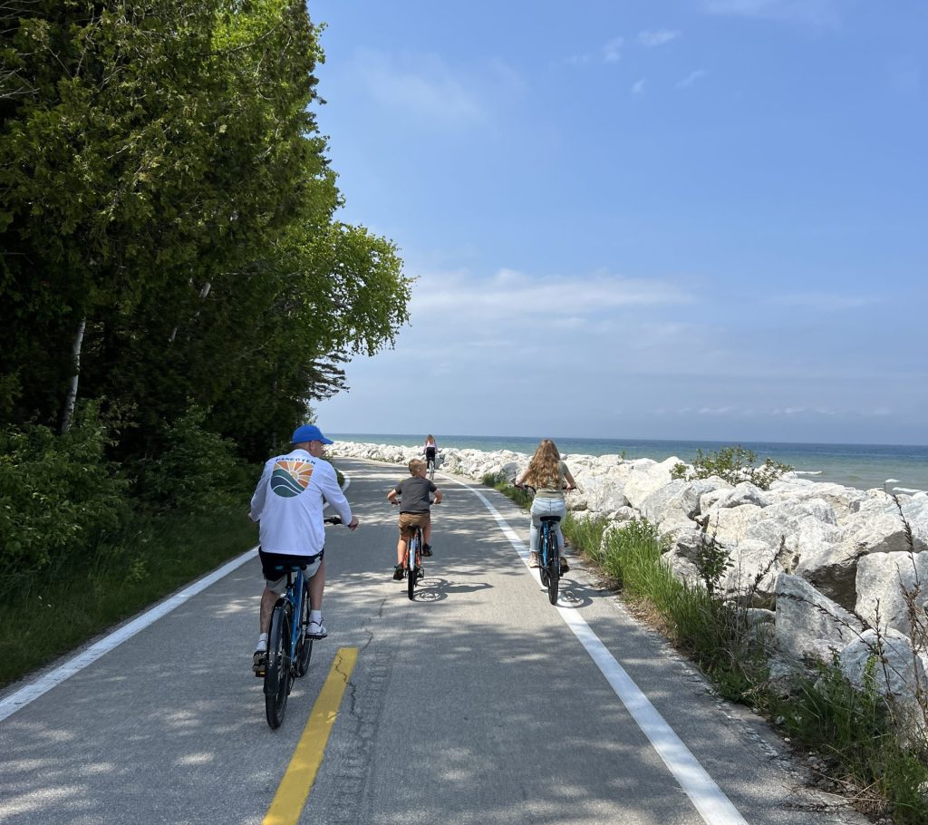 Family biking along M-185 on Mackinac Island MI